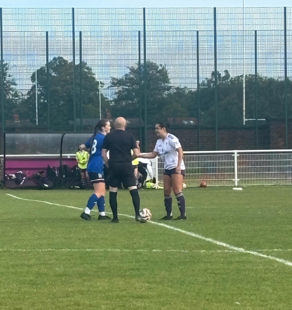 Team Elite captain Zara Gibbs shaking hands with the Manchester United captain before kick-off